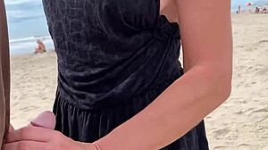Milf gives handjob on beach with big tits exposed. Public outdoor cum from monster cock?